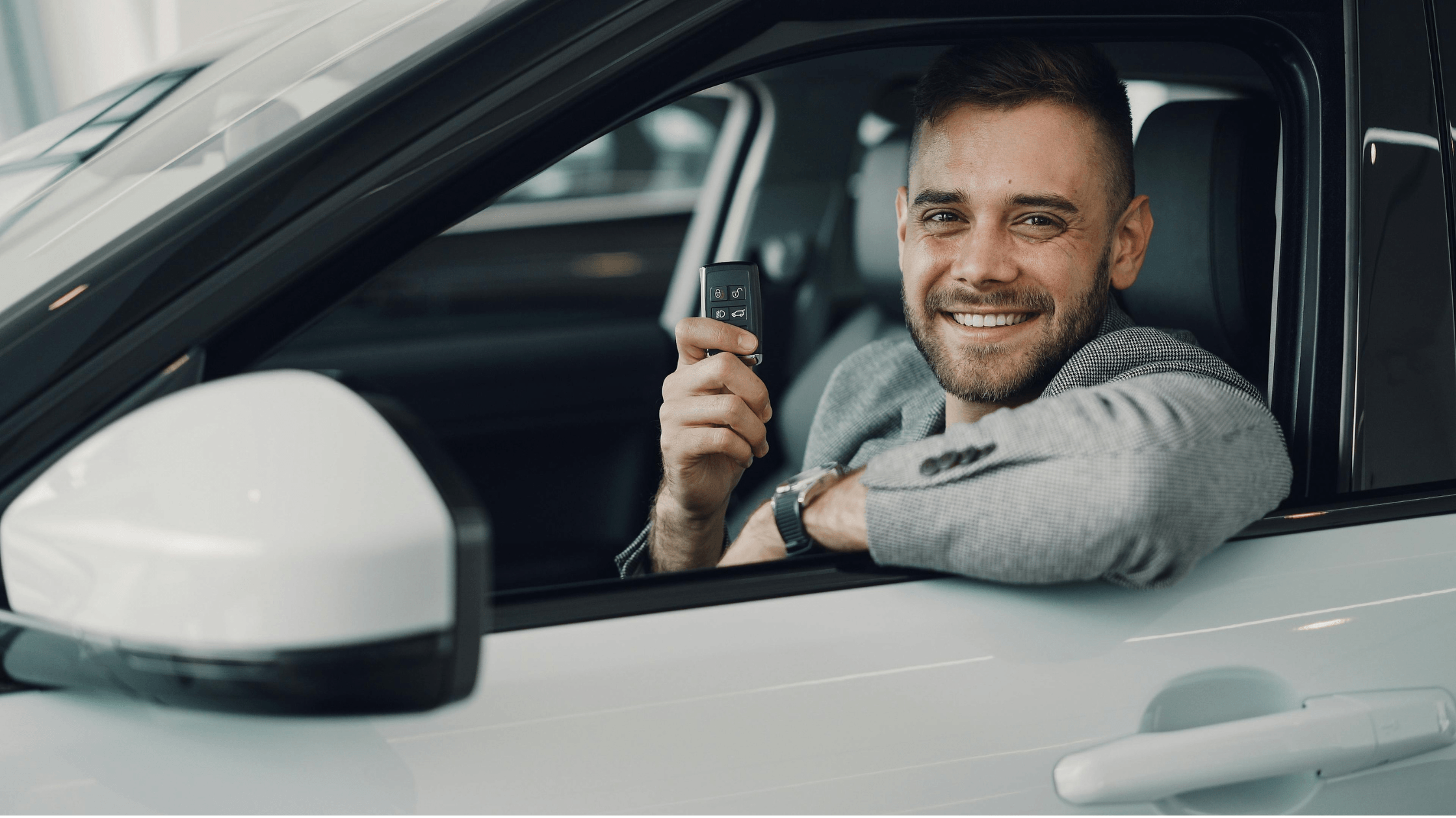 happy customer in their new car holding car keys