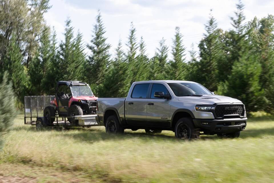 Ram truck pulling construction equitment