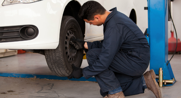 Auto technician working on a tire balance